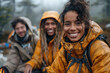 © Klay - cheerful friends wearing yellow jackets sharing a moment on a foggy hike
