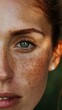© Beyonder - Close-up of a woman's freckled face partially obscured by a green leaf, showcasing natural beauty and skin positivity in a tropical setting.