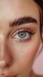 © sayan - Close-up of a woman's eye with a perfectly shaped eyebrow.