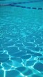 © MonkeyART - Close view of clear beautiful blue flowing water in swimming pool. Slow motion vertical video. Water surface. Travel and vacation concept. Summer
