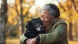 © armensl - African American woman with pet dog. Happy elderly african american woman at the park cuddling her dog. A senior african american woman playfully holding her dog in park. Love for animals concept.