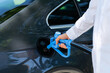 Man holds a hydrogen fueling nozzle. Refueling car with hydrogen fuel. Concept.