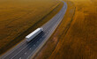 White Truck with Cargo Semi Trailer Moving on Autumn Road. Aerial Top Drone View