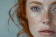 A close up of a redhead womans face highlighting her freckles and natural beauty