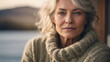 © KraPhoto - Serene Portrait of a Confident Mature Woman with Silver Hair, Wearing a Chunky Knit Sweater Overlooking a Scenic View