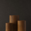 Wooden abstract podium for product demonstration. Oak pedestal on dark background