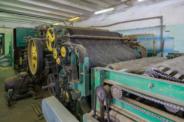 An old vintage machine in a workshop for the production of felt boots.