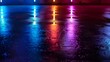 Colorful spotlights reflecting off wet asphalt with tire tracks at night