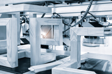 Poster - A machine is cutting wood into pieces