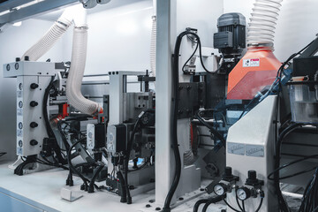 Poster - A machine is cutting wood into pieces