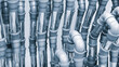 A series of pipes are shown in a close up. The pipes are silver and are arranged in a way that they look like they are connected to each other. Concept of organization and structure