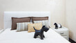A bed with a dog statue on it and a white pillow