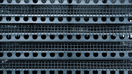 Aufkleber - A close up of a metal mesh with many holes. The holes are of various sizes and are arranged in a grid pattern. The image has a somewhat industrial and utilitarian feel to it