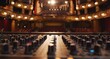 © progressman - a sound board in a large room with lights on the ceiling and a stage in the background with a row of seats..