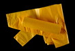 Yellow plastic garbage bag, isolated on black, top view	