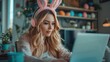 © hisilly - Businesswoman Working from Home Office with Bunny Ears Headphones and Easter Eggs in Background