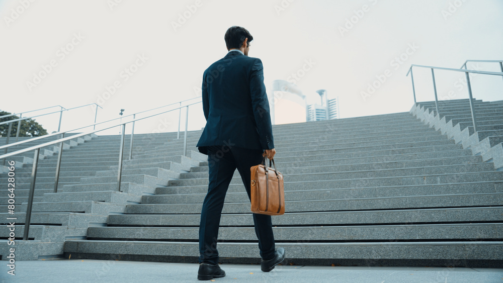 Top view of smart business man walking up stairs with bag in the hand ...