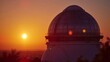 A sunset view of the observatory the warm orange and pink hues of the sky reflecting off its metallic surfaces.
