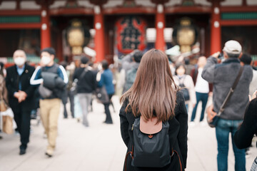 Wall Mural - Tourist woman visit Sensoji Temple or Asakusa Kannon Temple is a Buddhist temple located in Asakusa, Tokyo Japan. Japanese sentence on red lantern means Thunder gate.