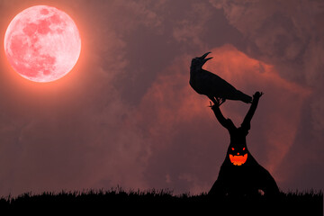 Wall Mural - The silhouette of a crow standing on a demonic tree in the atmosphere of a terrifying red full moon.