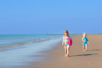 Wall Mural - Kids playing on beach. Children play at sea.