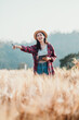 © Satori Studio - Enthusiastic farmer points out details in the wheat field while holding a digital tablet on a sunny day.