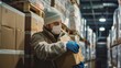 © Piyaphorn - Worker wearing protective gear stacking boxes of frozen meat in a cold storage room, organizing inventory for distribution.
