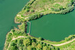aerial top view of river small dam in day sunlight. water rain irrigation dam reservoir. water diversion dam.