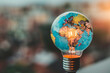 A globe is lit up inside a light bulb. The globe is surrounded by a blurry background