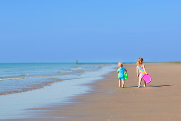 Wall Mural - Kids playing on beach. Children play at sea.