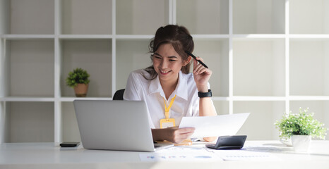 Wall Mural - Business woman using calculator for do math finance on wooden desk in office and business working background, tax, accounting, statistics and analytic research concept.