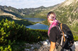 Adventure woman hiker on trial in Tatra Mountains in Poland. Back view.