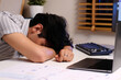 Young man sleepy, take a nap at work table, Overworked at night