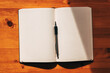 Journal or diary with blank mockup pages and a pen on the desk