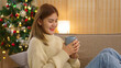 Winter holiday concept, Women drinking coffee while sitting to relaxation on comfortable couch