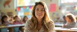 © khwanchai - Smiling Teacher in a Sunlit Elementary Classroom