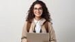 © khwanchai - Portrait of Young student woman looking camera with big smile and wearing backpack holding laptop over isolated white background