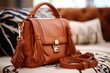Brown leather sling bag on sofa