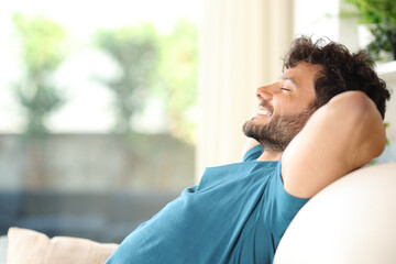 Wall Mural - Happy handsome man resting and relaxing at home