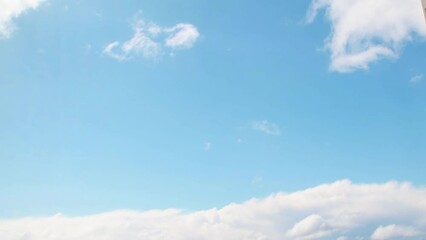 Wall Mural - Summer sky with white, cumulus clouds. Background with empty space for titles. Clouds frame copy space.