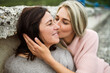 © Halfpoint - Adult daughter spending time with her mother outdoors. Beautiful daughter holding mother's face, kissing her cheek. Unconditional, deep maternal love, Mother's Day.