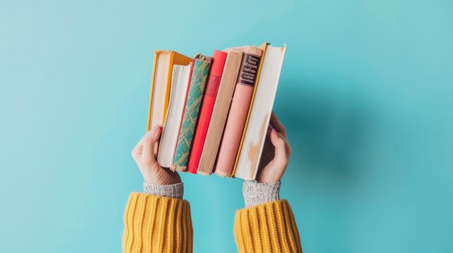Female hands cradle stack of books on light blue backdrop, Ai Generated