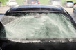 Cropped picture of high pressure gun washing car windshield at car wash station.