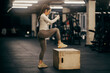 © Dusan Petkovic - A muscular sportswoman is practicing on a gym box.