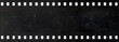 © siloto - Long strip of old celluloid film with dust and scratches