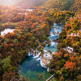 Fototapeta Big Ben - Krka, Croatia - Aerial panoramic view of the famous Krka Waterfalls in Krka National Park on a sunny autumn morning with colorful autumn foliage sunlight
