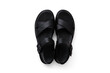 Black woman's leather sandals isolated on white background.
