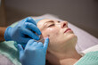 Injection facial rejuvenation. Biorevitalization and mesotherapy. A cosmetologist injects cosmetic preparations into the facial skin to moisturize, firm and rejuvenate the skin.