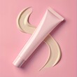 A tube of makeup is on a pink background