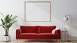 A red couch sits in front of a white wall with a large empty frame
